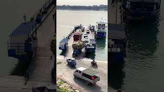 Truck driver carries paper shells off the boat and onto the ferry to cross the river. Safety is