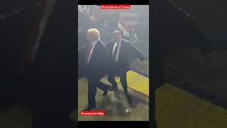 A secret service agent rushed to protect Donald Trump from a cellphone thrown at him in Pennsylvania