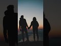 silhouette of a couple standing outdoors while holding each other s hands