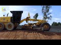 the incredible komatsu model motor grader is moving gravel working on a rural road building project