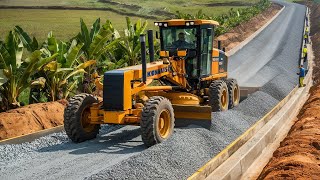 The incredible KOMATSU model motor grader is moving gravel working on a rural road-building project