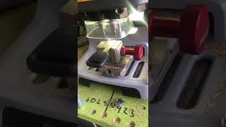 Honda key being cut