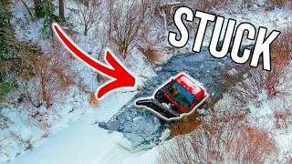 SNOW CAT FALLS THROUGH CREEK