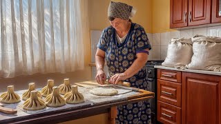 Happy old age of an elderly woman in a mountain village in winter far from civilization