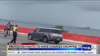 Protester fights to have charges dropped