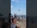 Hundreds of thousands of dragonflies swarm beachgoers