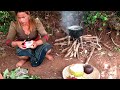 woman catch fish in field and cook with coconut water