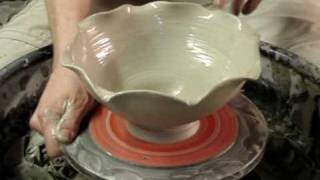 Attempting to make a  clay pottery flower shaped bowl on a potters wheel demo