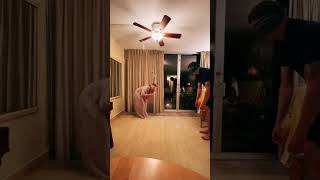 Couple Plays Blindfold Game With Bottle Attached to Moving Fan - 1352371