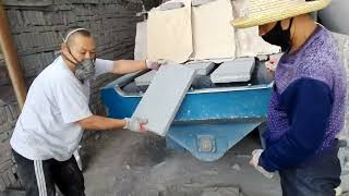 floor paver tile shot blasting machine working to make tile a rough nature stone surface