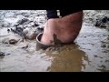 tall rubber wellie boots in deep mud