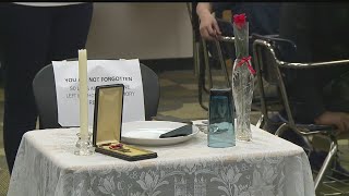 Empty table resonates with Warren middle schoolers learning about military sacrifice