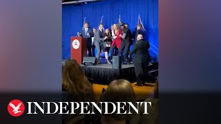 Moment protesters run on stage during Ron DeSantis speech