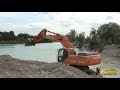 doosan dx300 excavator digging gravel under water