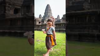 A cute 5-year-old Khmer girl, a flower in her hand