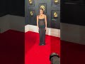 Olivia Rodrigo posing on the Grammy red carpet