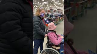 Maggie pushing El at Costco