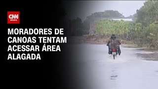 Moradores de Canoas tentam acessar área alagada | AGORA CNN