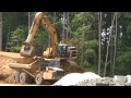 caterpillar 345bl excavator loading cat d250e adt