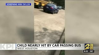 Child nearly hit by car passing bus