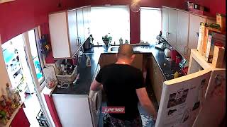 Man drops milk bottle on kitchen floor