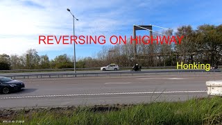 Taxi Reversing on Highway Shoulder