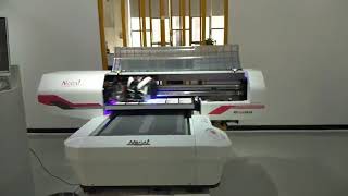 Nuocai UV digital printer is printing the name card.