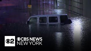 Strong storms downed trees, power lines and submerged cars across the New York area