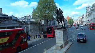 London open air bus driving by the Royal Guards