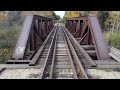 4k drone view of an old railroad bridge in amasa michigan