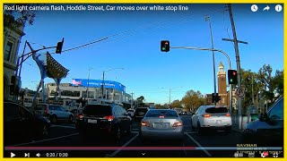 Red light camera flash, Hoddle Street, Car moves over white stop line