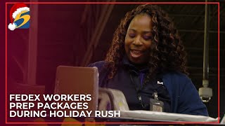 FedEx workers prep packages during holiday rush