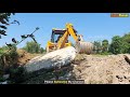 jcb 3dx eco backhoe loader throwing out heavy concrete slab from road jcb earth movers working