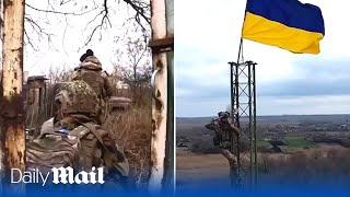 Ukraine border guards hoist flag in Budarky after soldiers battled north of Kharkiv