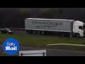 The moment HGV almost causes accident reversing in busy traffic - Daily Mail