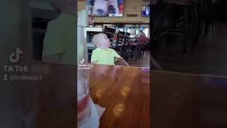 Toddler stares at the waitress in Hooters restaurant 😄