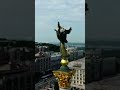 manifestaÇÃo espÍritual na ukrÂnya um monumento mulher anjo cabeÇa rosto de dragÃo sobre a terra...