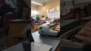 student uses typewriter in class