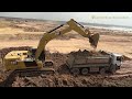 heavy powerful caterpillar 336 excavator digging loading dump trucks