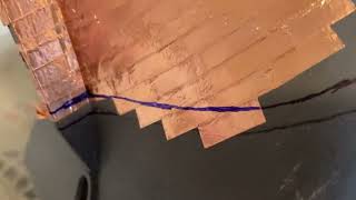 Laying copper plate on the hull in the proper gore patterns