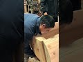 craftsmen are assembling a pure wooden coffin