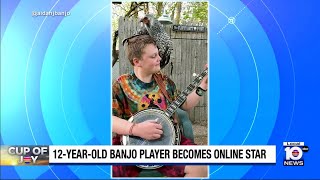 Young banjo player goes viral after playing with chicken on his shoulder