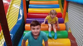 Alena and Pasha are playing at the indoor playground for children