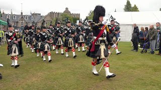 Drum Major leads the Lonach Pipe Band on the march into the 2023 Aboyne Highland Games in Scotland