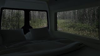 Rain on windows of car for camping in forest | car camping