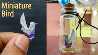 Miniature origami bird in a Glass bottle