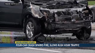 Four-car crash sparks fire, slows rush hour traffic