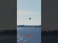 hot air balloon flying over ocean cay island while mega ships docked hotairballoon fly sky views