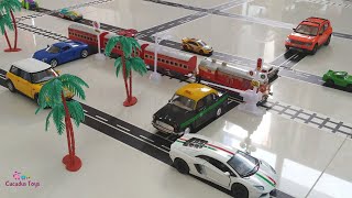 Cucudus play with toy trains and toy cars at railroad crossing | Indian passenger train