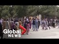 Afghans desperate to leave country crowd outside of Kabul airport